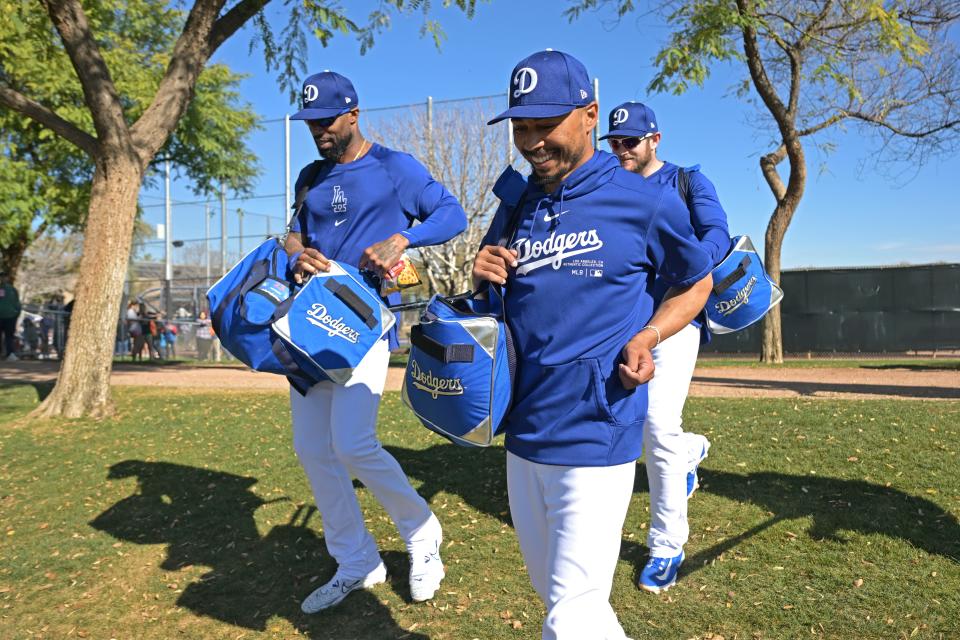 Dodgers players walk to the field for spring training drills in Arizona.