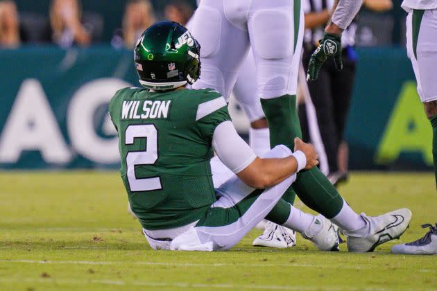 New York Jets quarterback Zach Wilson holds his knee after injuring it during a preseason game against the Philadelphia Eagles on Friday. (Photo: Icon Sportswire via Getty Images)