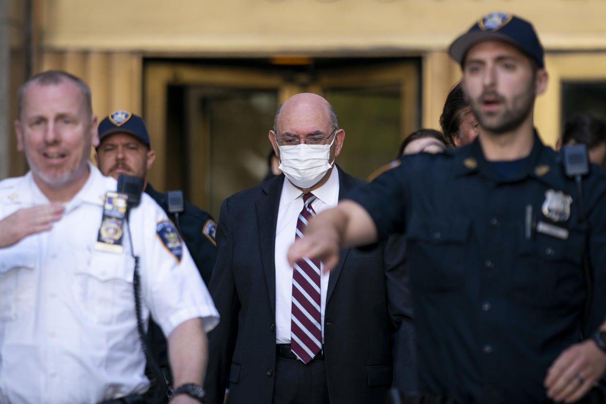 Law enforcement personnel escort the Trump Organization's former Chief Financial Officer Allen Weisselberg, center, as he departs court, Friday, Aug. 12, 2022, in New York. (AP)