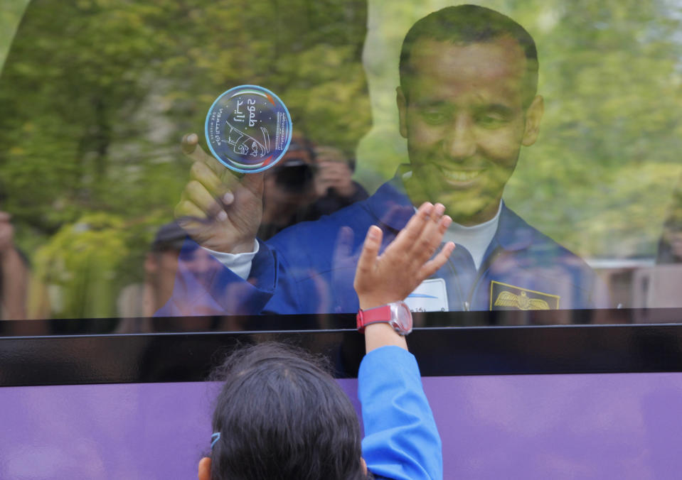 United Arab Emirates astronaut Hazza Al Mansouri, a member of the main crew to the International Space Station (ISS), gestures to his relatives from a bus prior to the launch of Soyuz-FG rocket at the Russian leased Baikonur cosmodrome, Kazakhstan, Wednesday, Sept. 25, 2019. (AP Photo/Dmitri Lovetsky)