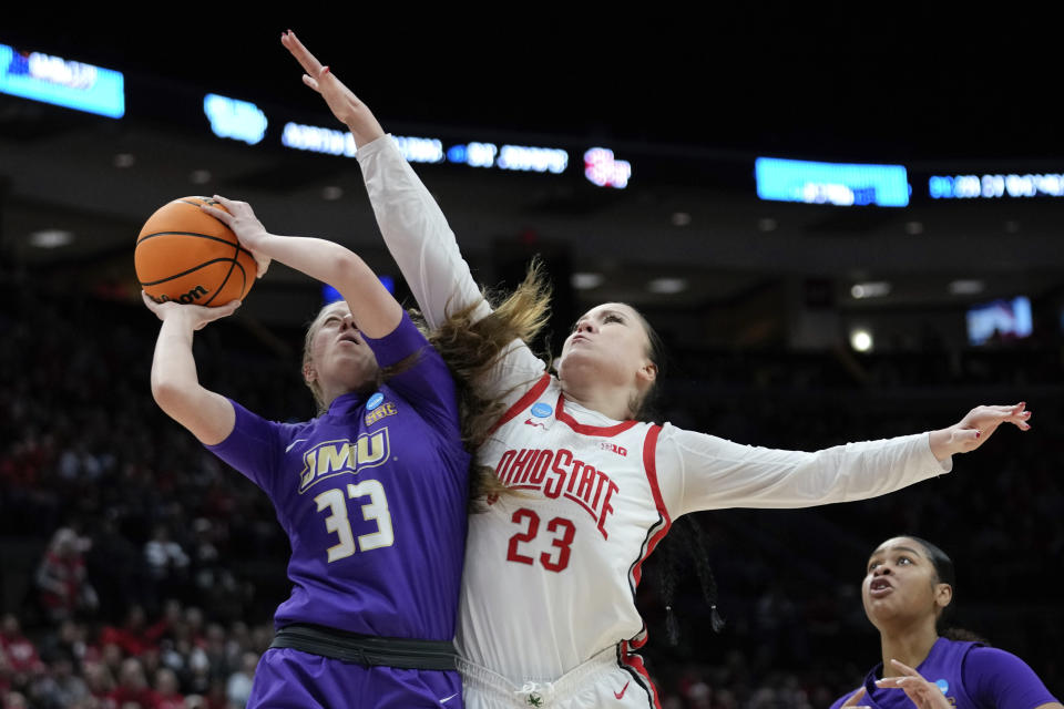 James Madison forward Steph Ouderkirk (33) shoots on Ohio State forward Rebeka Mikulasikova (23) in the second half of a first-round women's college basketball game in the NCAA Tournament Saturday, March 18, 2023, in Columbus, Ohio. (AP Photo/Paul Sancya)