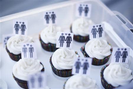 A box of cupcakes are seen topped with icons of same-sex couples at City Hall in San Francisco in this file photo taken June 29, 2013. REUTERS/Stephen Lam/Files