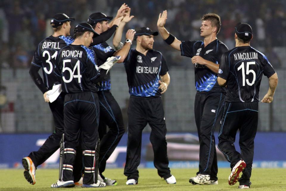 New Zealand's cricket captain Brendon McCullum, center, celebrates with teammates the dismissal of an England wicket during an ICC Twenty20 Cricket World Cup match in Chittagong, Bangladesh, Saturday, March 22, 2014. (AP Photo/Bikas Das)