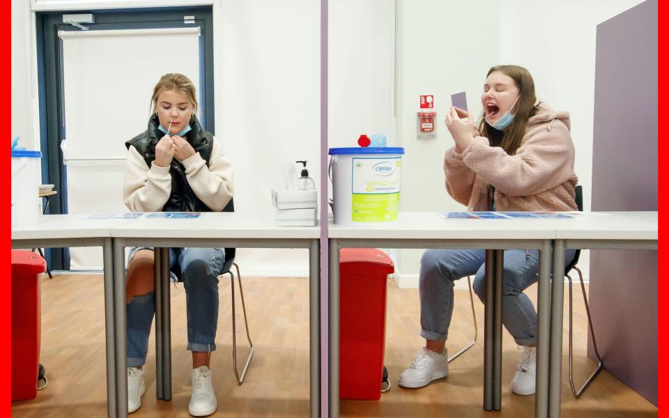 Students Ellie Fisher (left) and Beth Hicks (right) take Coronavirus lateral flow tests at Outwood Academy Adwick - Danny Lawson/PA