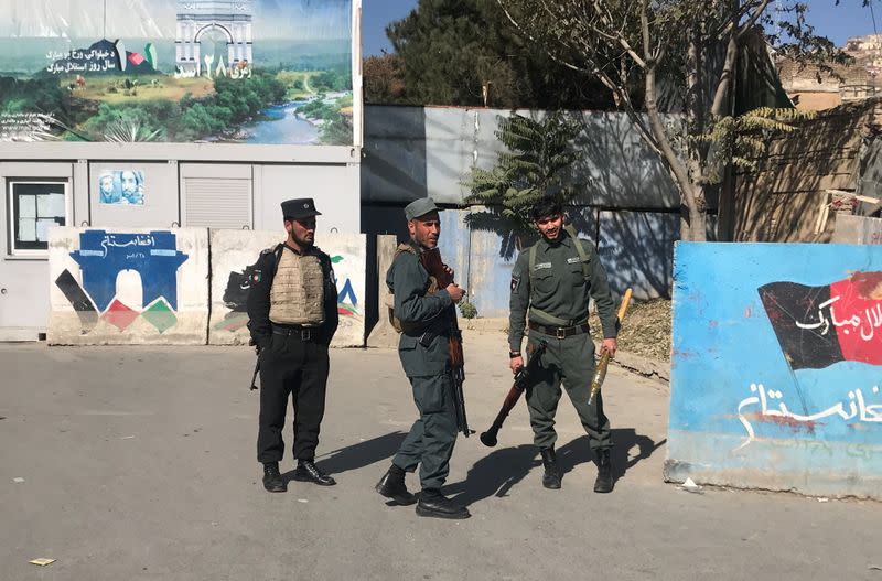 Afghan policemen keep watch near the site of an attack in Kabul