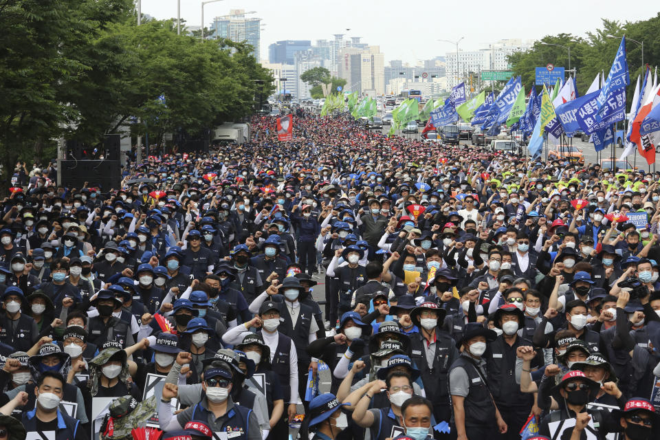 Workers wearing face masks to help protect against the spread of the new coronavirus stage a rally against the government's labor policy in Seoul, South Korea, Wednesday, June 10, 2020. (AP Photo/Ahn Young-joon)