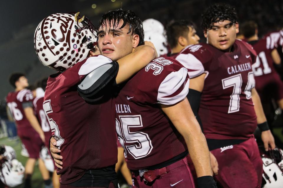 Calallen's Ernest Hinojosa (35) hugs Bryce Burnett (5) after a Class 4A Division I regional final high school football game against Boerne at Alamo Stadium on Friday, Dec. 2, 2022 in San Antonio, Texas. The Wildcats lost 49-19, ending their season.