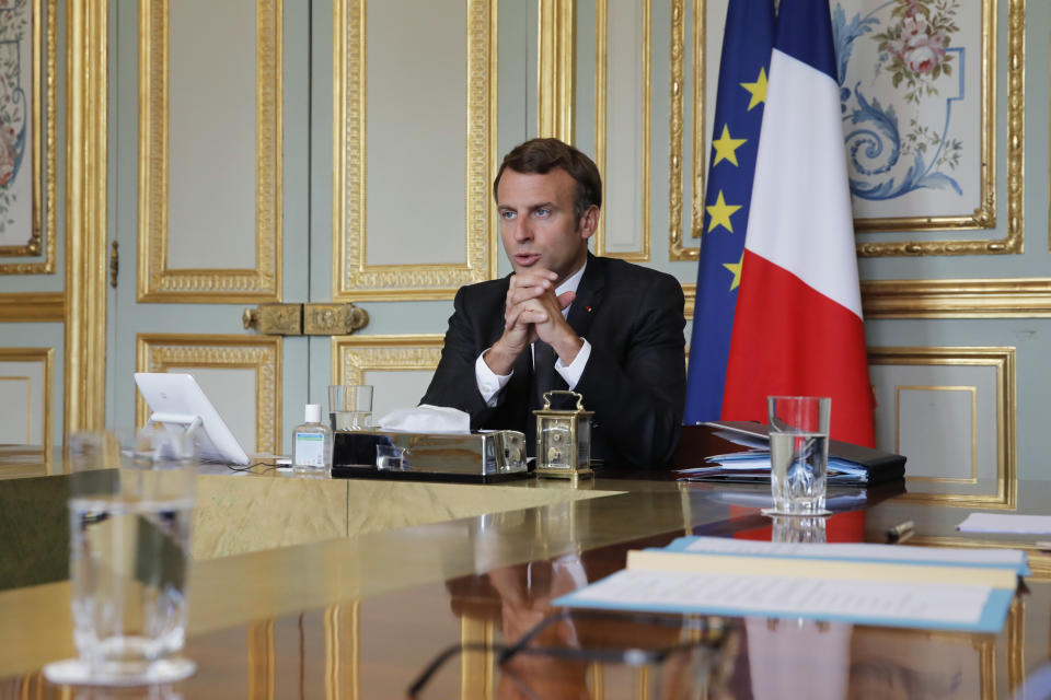 France's President Emmanuel Macron attends a visio conference with Kosovo Prime Minister Avdullah Hoti, Serbian President Aleksandar Vucic, and German Chancellor Angela Merkel, at the Elysee Palace, in Paris, Friday, July 10, 2020. The leaders of Serbia and Kosovo will hold talks in Brussels on July 12, the first meeting between the two in long-stalled European Union-supervised negotiations aimed at normalizing relations, European Commission spokesman Peter Stano said Monday. (AP Photo/Christophe Ena, Pool)