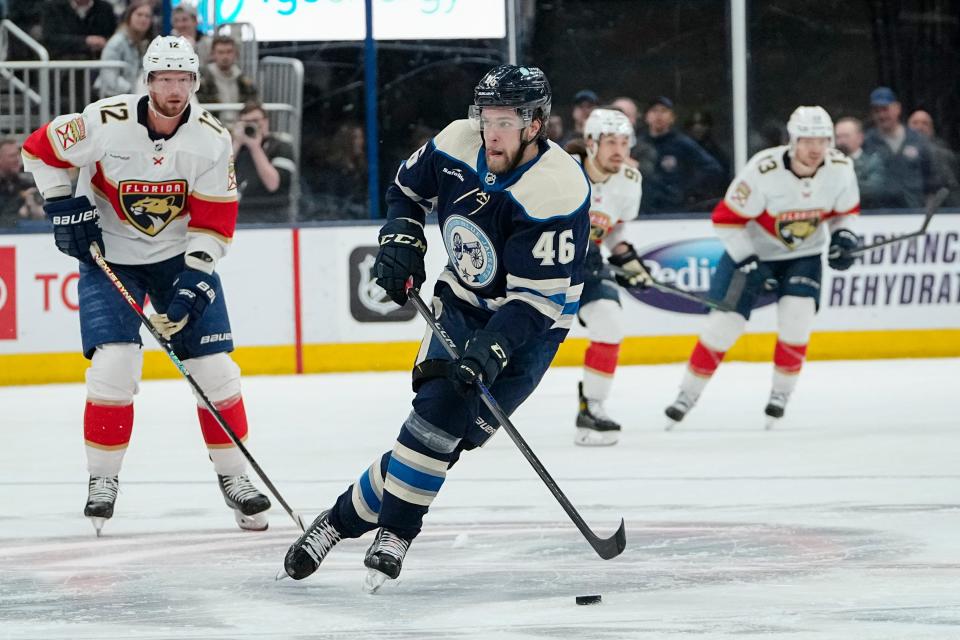 Columbus Blue Jackets left wing Joona Luoto (46) brings the puck up ice past Florida Panthers center Eric Staal (12) during the first period of the NHL hockey game at Nationwide Arena on April 1, 2023.