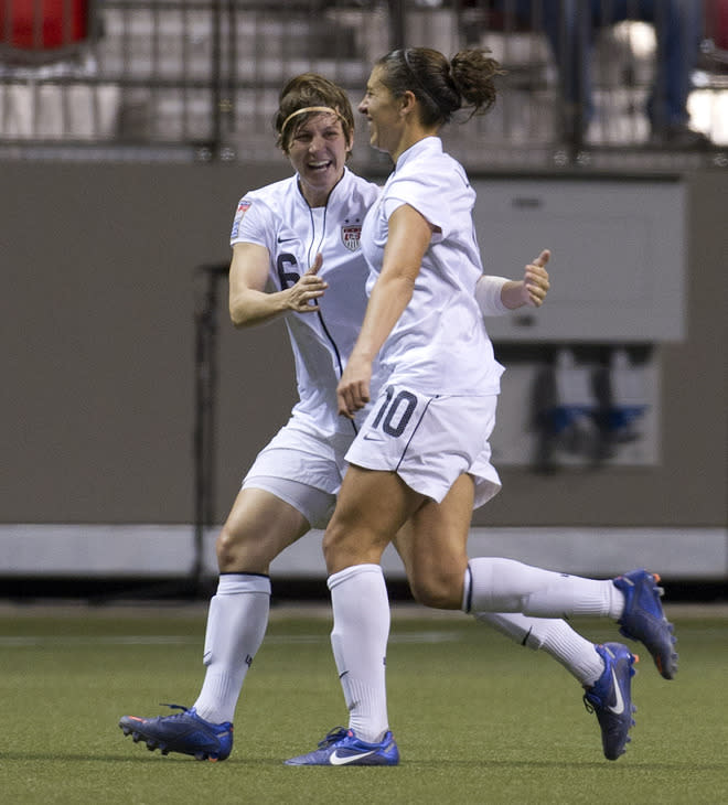 VANCOUVER, CANADA - JANUARY 27: Amy LePeilbet #6 of the United States congratulates Carli Lloyd #10 after scoring a goal against Costa Rica during the second half of semifinals action of the 2012 CONCACAF Women's Olympic Qualifying Tournament at BC Place on January 27, 2012 in Vancouver, British Columbia, Canada. (Photo by Rich Lam/Getty Images)