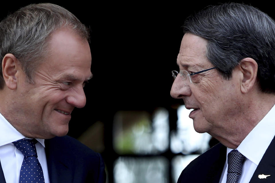 Cyprus' President Nicos Anastasiades, right, talks with European Council President Donald Tusk as he arrives for a meeting at the presidential palace in divided capital Nicosia, Cyprus, Friday, Oct. 11, 2019. Tusk is in Cyprus for one-day visit. (AP Photo/Petros Karadjias)