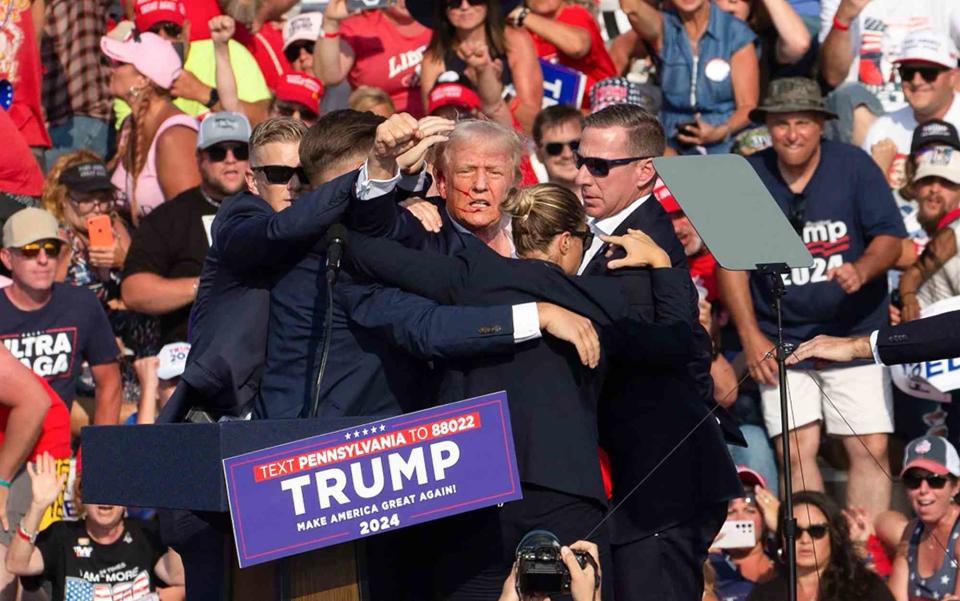 <p>Rebecca DROKE / AFP) (Photo by REBECCA DROKE/AFP via Getty</p> Donald Trump following the shooting at his July 13 rally in Pennsylvania.