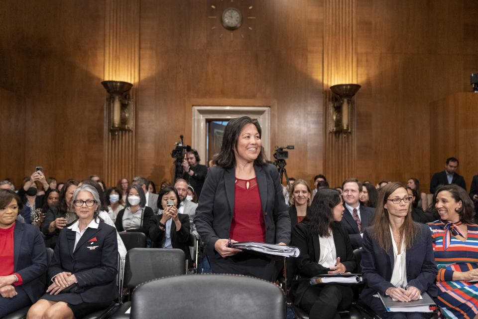 Julie Su, center, takes her seat for a Senate Health, Education, Labor and Pensions confirmation hearing for her to be the Labor Secretary, on Capitol Hill, Thursday, April 20, 2023, in Washington. (AP Photo/Alex Brandon)