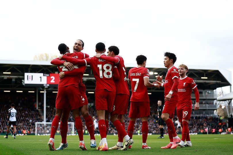 Liverpool's Dutch midfielder #38 Ryan Gravenberch (L) celebrates scoring the team's second goal with Liverpool's Dutch defender #04 Virgil van Dijk during the English Premier League football match between Fulham and Liverpool at Craven Cottage in London on April 21, 2024.