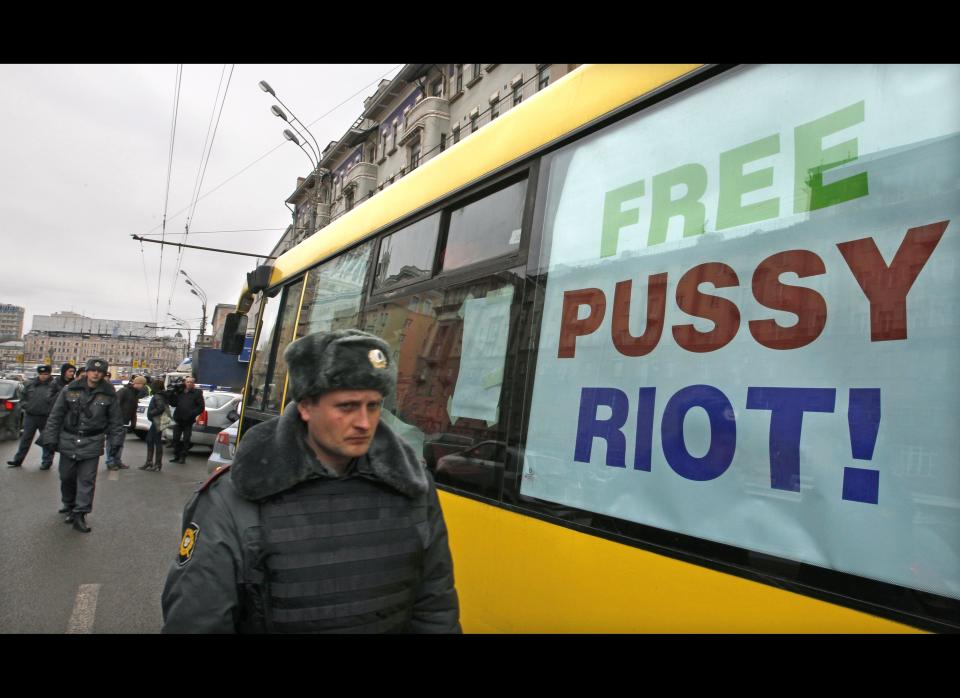 A police officer walks outside a bus before it departs for a city tour supporting the female punk protest group.