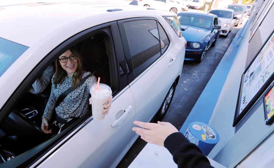 Cape Coral resident Morgan Dexter, grabs her beverage during a visit to Urban Buzz Coffee Company in Cape Coral Thursday, February 4, 2021. 