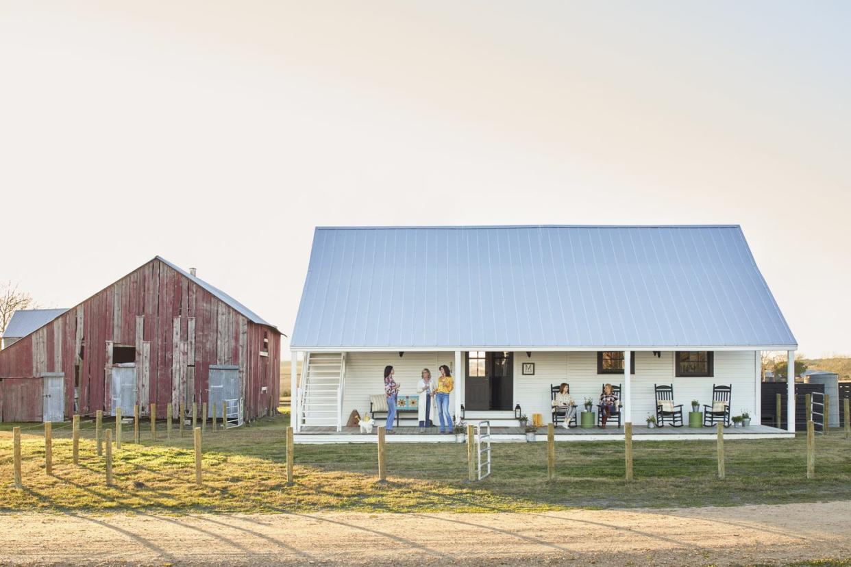 small white farmhouse and red barn