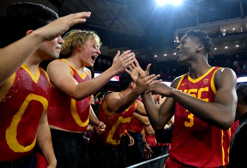 LOS ANGELES, CA - JANUARY 26: Vincent Iwuchukwu #3 of the USC Trojans celebrates with students after defeating the UCLA Bruins at Galen Center on January 26, 2023 in Los Angeles, California. (Photo by Jayne Kamin-Oncea/Getty Images)