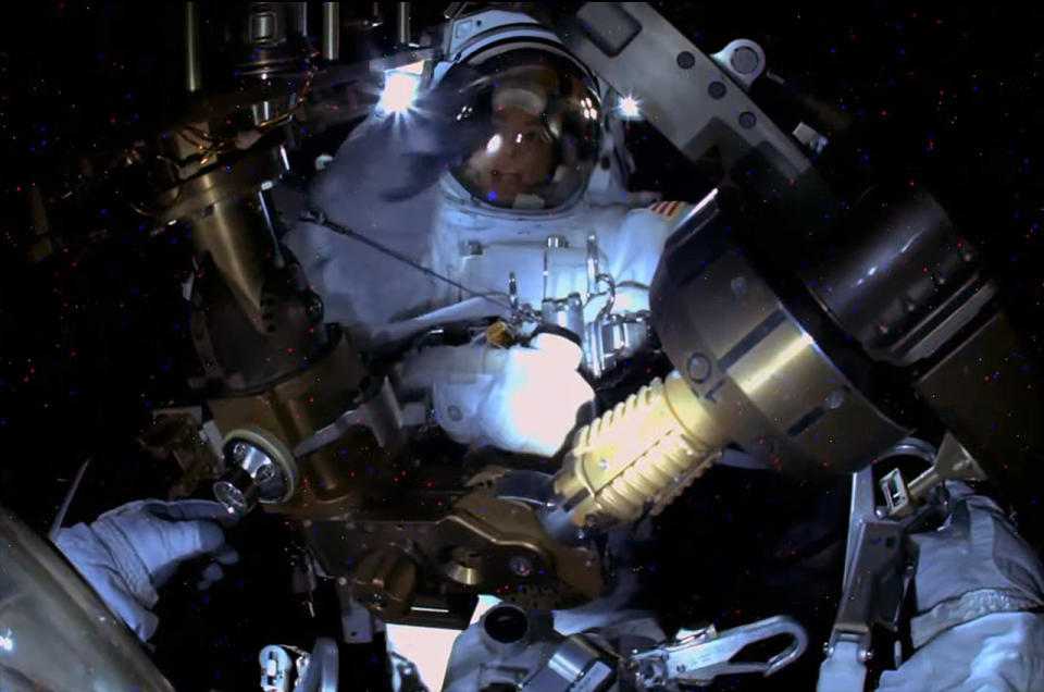 NASA astronaut Nicole Mann is seen by a camera mounted on the helmet worn by Koichi Wakata of the Japan Aerospace Exploration Agency (JAXA) during a spacewalk outside of the International Space Station on Friday, Jan. 20, 2023. Between the two astronauts is an articulated portable foot restraint (APFR).