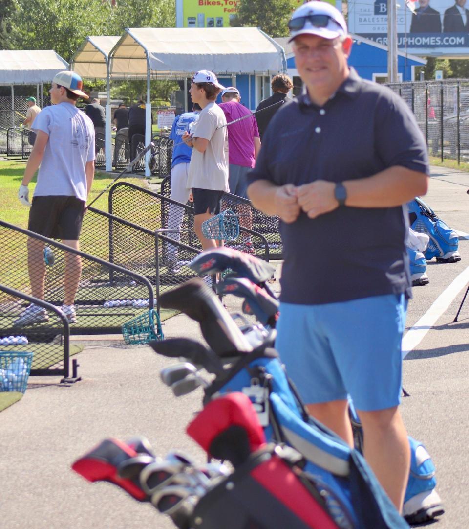 Auburn boys' golf coach Dave Stanick at Auburn Driving Range with his team.