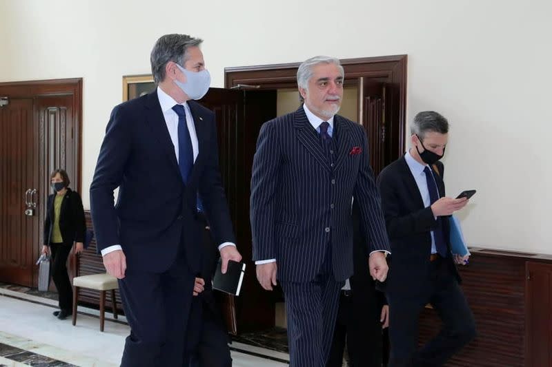 U.S. Secretary of State Antony Blinken walks with Chairman of the High Council for National Reconciliation Abdullah Abdullah in Kabul