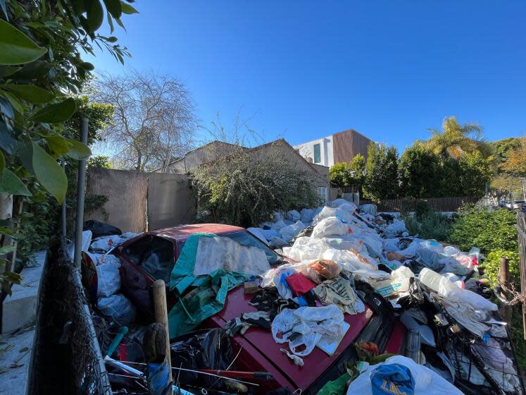 The trash-strewn home of Raymond Daon in the 600 block of North Martel Avenue in Fairfax district of Los Angeles, photographed on April 2, 2024. Neighbors have complained for years about the property, and the city has launched a code enforcement investigation. (Matt Hamilton / Los Angeles Times)