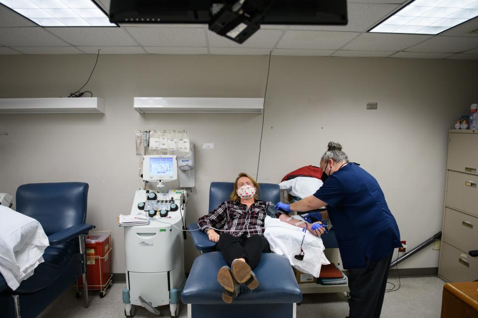 Phlebotomist Christina Clark, right, gets Chris Malloy hooked up to donate platelets at Cape Fear Valley Blood Donor Center on Tuesday, Dec. 7, 2021.