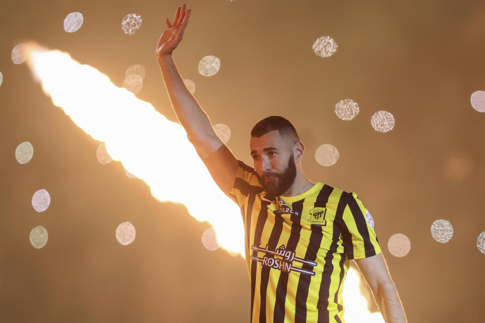 FILE - Saudi soccer team Al Ittihad player Karim Benzema greets Saudi fans during his presentation ceremony at King Abdullah Sports City Stadium in Jeddah, Saudi Arabia, June 8, 2023. The Saudi Arabian soccer league kicks off Friday Aug. 11, 2023 after a spending spree on players grabbed the world’s attention in the European summer offseason. Now the actual games start and the appeal of watching newly recruited Champions League winners like Karim Benzema, Sadio Mane and Riyad Mahrez — who have followed the January trailblazer Cristiano Ronaldo into unfamiliar surroundings — will be tested. (AP Photo/File)