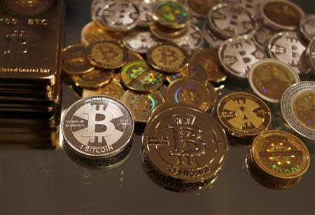 Bitcoins created by enthusiast Mike Caldwell are seen in a photo illustration at his office in Sandy, Utah, in this September 17, 2013 file photo. Mt. Gox, once the world's biggest bitcoin exchange, looked to have essentially disappeared on February 25, 2014, with its website down, its founder unaccounted for and a Tokyo office empty bar a handful of protesters saying they had lost money investing in the virtual currency. REUTERS/Jim Urquhart/Files