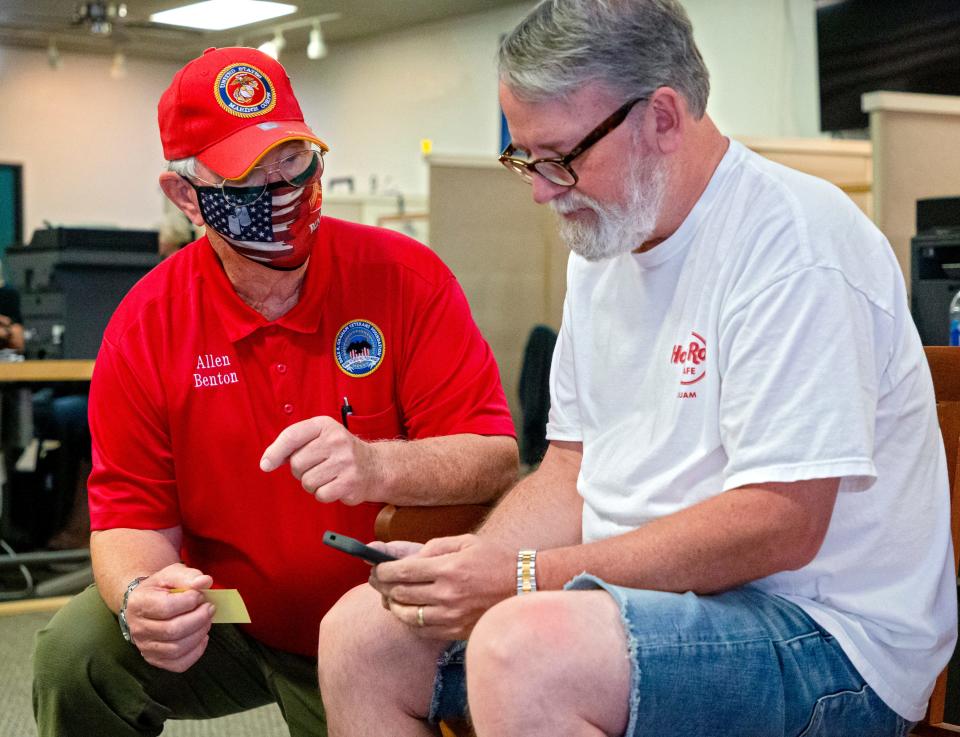 Allen Benton, client and volunteer at the Dale K. Graham Veterans Foundation helps client John Prokup at the organizationÕs office on Thursday, Aug. 5, 2021, in Norman, Okla. Benton, who was on the verge of homelessness after returning from Vietnam, was able to get services from Dale K. Graham Veterans Foundation in obtaining 100 percent of his VA benefits. 