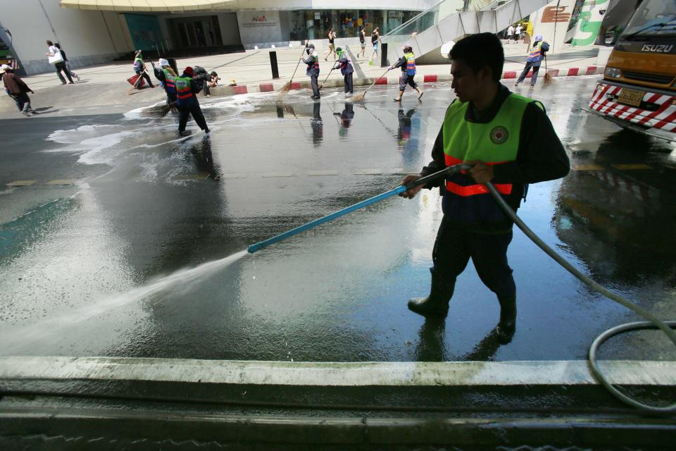 City workers clean a main protest site as it is cleared from a popular intersection in Bangkok, Thailand, Sunday, March 2, 2014. The anti-government protesters withdrew from several stages erected at key intersections around Bangkok. Starting Monday, they will consolidate at Lumpini Park, a central venue that has become a traditional protest site. (AP Photo/Wally Santana)