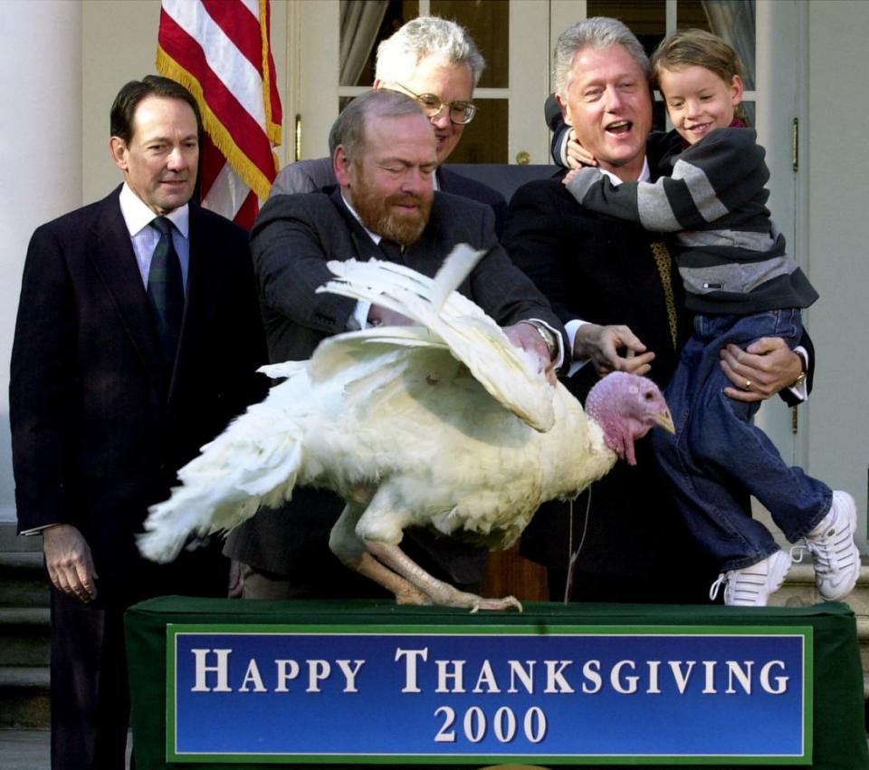 President Bill Clinton, holding his nephew Tyler, 6, grants a “pardon” to a turkey named “Jerry,” from Barron Wis., during the annual Thanksgiving Turkey Presentation at White House, in Washington Wednesday, Nov. 22, 2000. Placing the turkey on the table is Nickolas Feidt, the man who raised it. Standing in the background, from left, are Stuart Proctor, Jr., and Jerry Jerome, chairman of the National Turkey Federation. Clinton’s action in the Rose Garden spared the bird, so he won’t become someone’s meal. It will instead go to a petting zoo in Herndon, Va. ( Photo: Kenneth Lambert/AP)