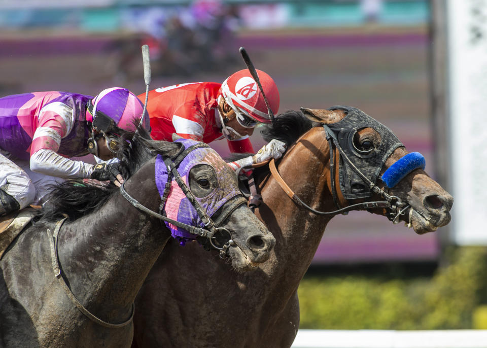 In a photo provided by Benoit Photo, Practical Move and jockey Ramon Vazquez, inside, nose out Mandarin Hero, with Kazushi Kimura, for victory in the Grade I, $750,000 Santa Anita Derby horse race Saturday, April 8, 2023, at Santa Anita in Arcadia, Calif. (Benoit Photo via AP)