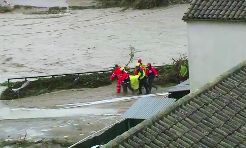 In this image made from video provided by Atlas, emergency services carry an injured woman on a stretcher, in Ontiyente, Spain, Thursday, Sept. 12 2019. A large area of southeast Spain was battered Thursday by what was forecast to be its heaviest rainfall in more than a century, with the storms wreaking widespread destruction and killing at least two people. (Atlas via AP)