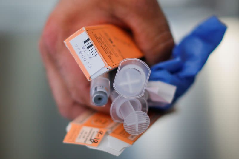 FILE PHOTO: A Cataldo Ambulance medic holds used doses of naloxone after medics revived a man in his 40's who was found unresponsive from an opioid overdose in the Boston suburb of Salem