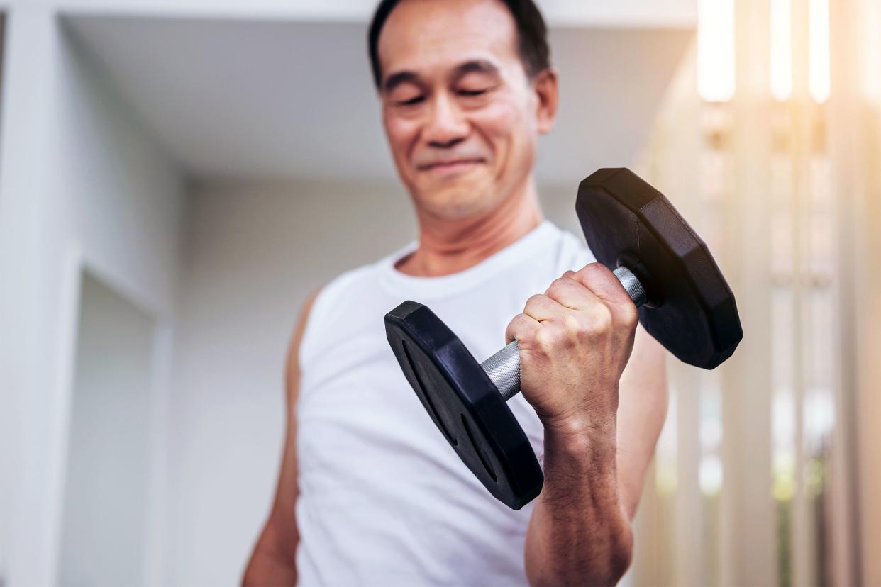 Senior man lifting weights