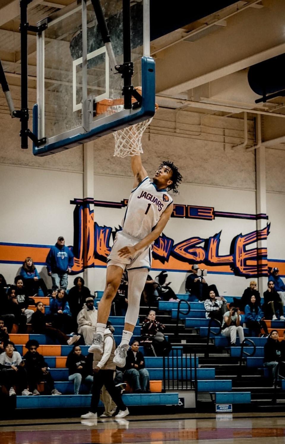 Kimball's Jaden Ryan goes up to dunk the basketball during one of the Jaguars games during the 2023-24 season.