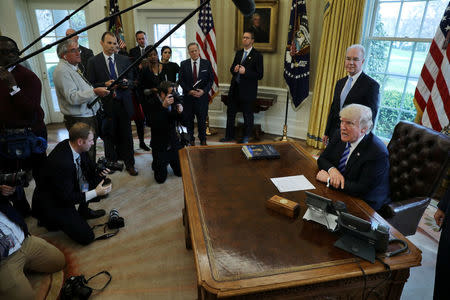 U.S. President Donald Trump talks to journalists at the Oval Office of the White House after the AHCA health care bill was pulled before a vote in Washington, U.S. March 24, 2017. REUTERS/Carlos Barria