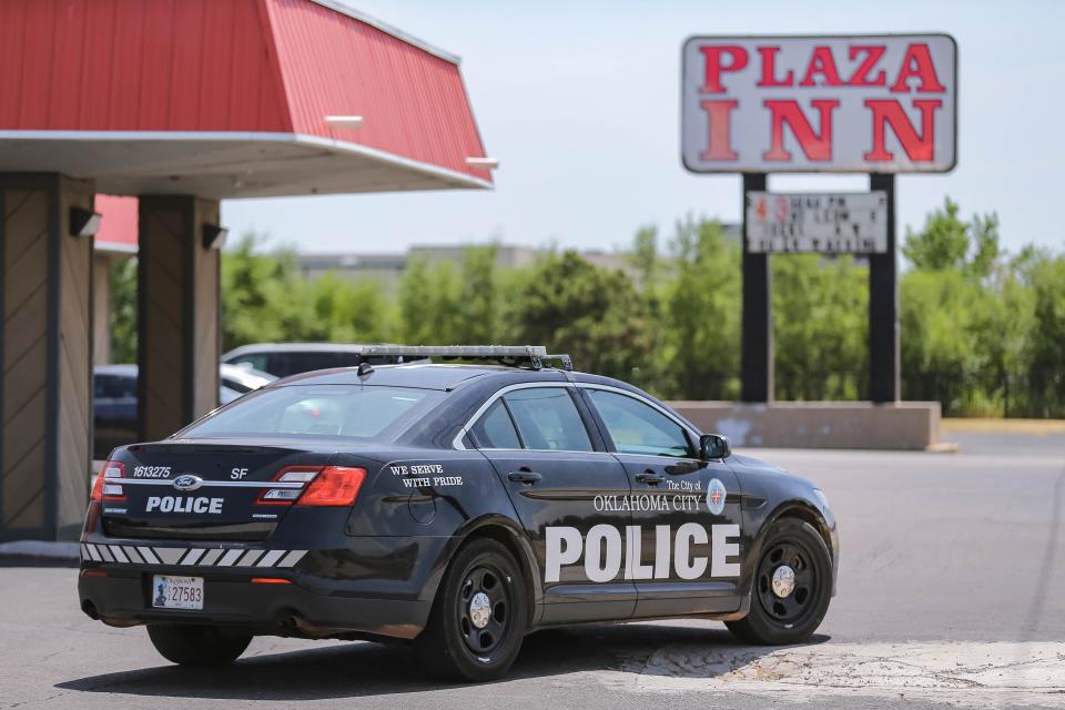 Police patrol through the Plaza Inn parking lot Aug. 9, 2022, in Oklahoma City.