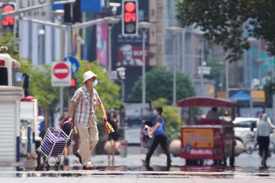 Pedestrians during a heatwave in Shanghai in July (Aly Song/Reuters)