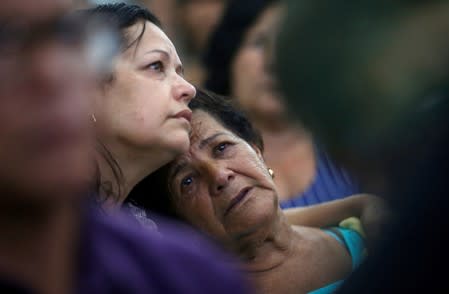 FILE PHOTO: Relatives and friends of victims of a collapsed tailings dam owned by Brazilian mining company Vale SA, pay their respects during a mass in Brumadinho