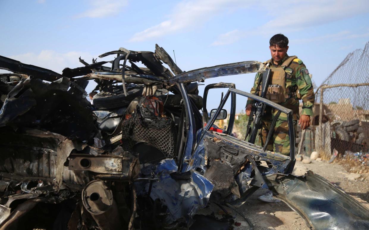 Afghan security officials inspect the scene of a roadside bomb blast that killed six civilians on the outskirts of Jalalabad, Afghanistan on Wednesday - Ghulamullah Habibi/EPA-EFE/Shutterstock