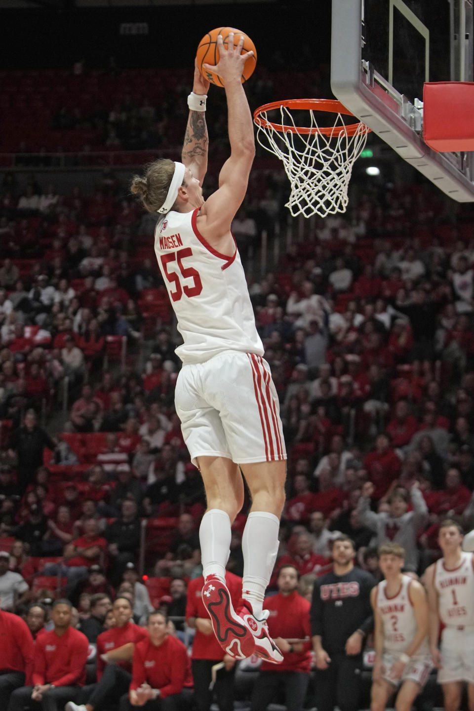 Utah guard Gabe Madsen (55) goes up to dunk against Colorado during the second half of an NCAA college basketball game Saturday, Feb. 3, 2024, in Salt Lake City. (AP Photo/Rick Bowmer)