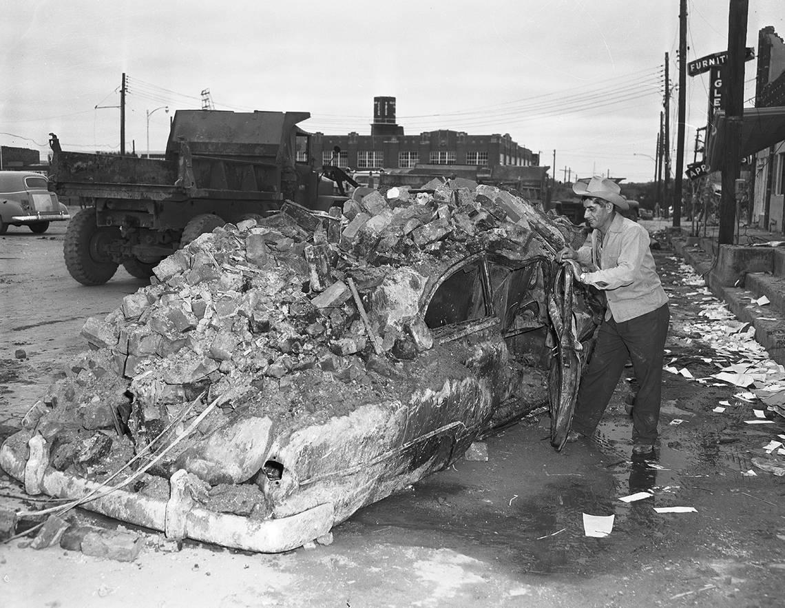 Nick Tusa, owner of Nick’s Fish Market on East Second Street in Waco, left this car seconds before a tornado struck in 1953. Power lines set fire to the car and bricks from his market crashed down on it. Tusa, who sought cover in his market, escaped from his business by pushing through debris. Fort Worth Star-Telegram Collection/UT Arlington Special Collections