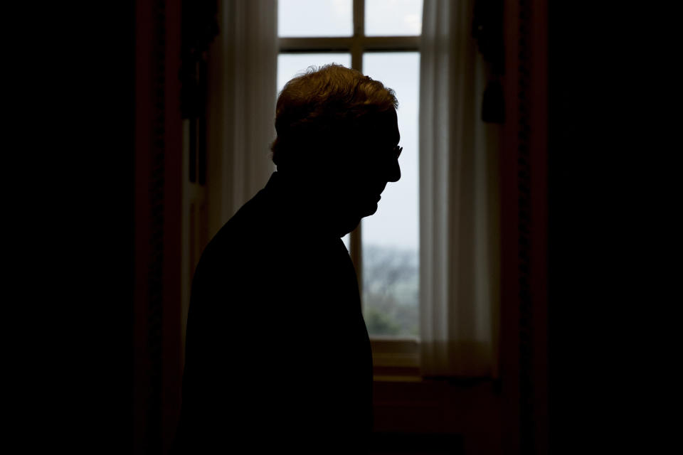 FILE - In this March 23, 2020, file photo Senate Majority Leader Mitch McConnell of Ky. walks to the Senate Chamber on Capitol Hill in Washington as the Senate is working to pass a coronavirus relief bill. When Republicans took control, McConnell pushed it to the next level with President Donald Trump, eliminating the filibuster for Supreme Court pick. McConnell critics say he is breaking the Senate, but Trump has been able to install two Supreme Court justices on majority-only votes, and the Senate is poised to confirm a third, Judge Amy Coney Barrett, on Monday, Oct. 26. (AP Photo/Andrew Harnik, File)