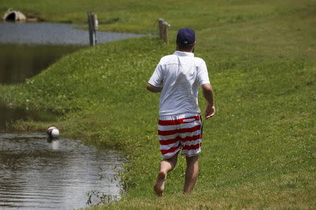 A FootGolfer heads to retrieve his ball out of a water hazard at Largo Golf Course in Largo, Florida April 11, 2015. REUTERS/Scott Audette