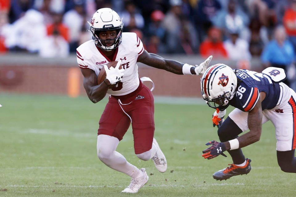 New Mexico State wide receiver Jonathan Brady (6) carries the ball as Auburn cornerback Jaylin Simpson (36) pursues during the first half of an NCAA college football game Saturday, Nov. 18, 2023, in Auburn, Ala. (AP Photo/Butch Dill)