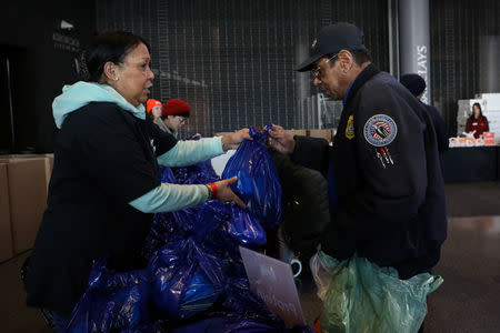A Transportation Security Administration (TSA) employee receives a donation at a food distribution center for federal workers impacted by the government shutdown, at the Barclays Center in the Brooklyn borough of New York, U.S., January 22, 2019. REUTERS/Brendan McDermid