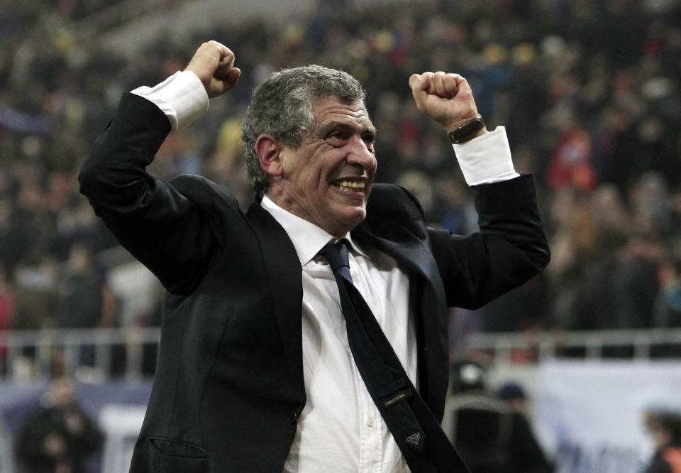 FILE - In this Tuesday, Nov. 19, 2013 file photo, Fernando Santos, the coach of Greece, celebrates after defeating Romania in their World Cup qualifying playoff second leg match at the National Arena in Bucharest. Greece's Football Association said Thursday Feb. 27, 2014, that national coach Fernando Santos will step down following the World Cup in Brazil, after a successful four-year term on the job that saw the country rise to 12th place in the the FIFA world rankings. (AP Photo/Thanassis Stavrakis, File)