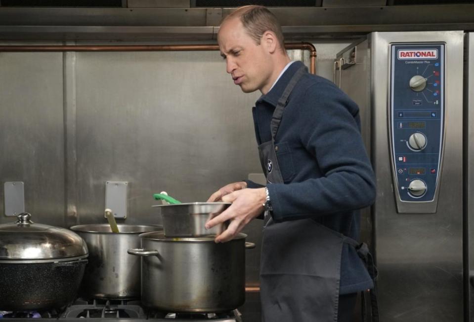 The heir to the throne chatted to volunteers and lent a helping hand in the kitchen. AP